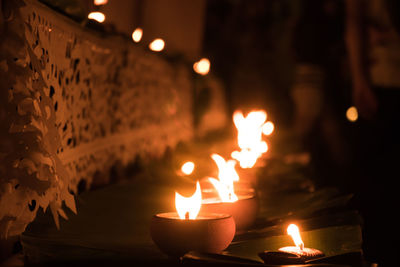 Close-up of illuminated diyas