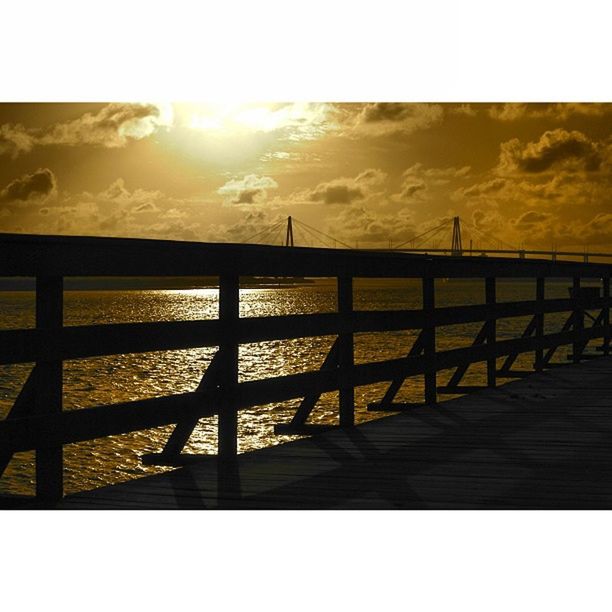 sunset, railing, tranquil scene, tranquility, scenics, fence, sky, beauty in nature, sun, sunlight, nature, transfer print, landscape, idyllic, water, auto post production filter, mountain, sea, sunbeam, outdoors