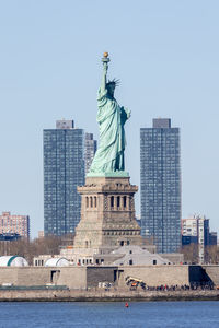 Statue of liberty with jersey city in the background