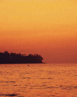 Scenic view of sea against orange sky