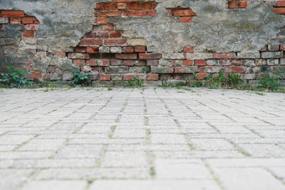 Stone wall by street in city