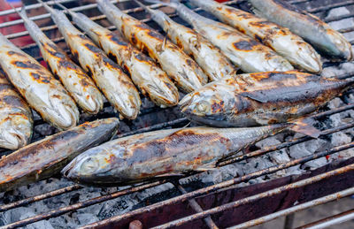 High angle view of fish on barbecue grill