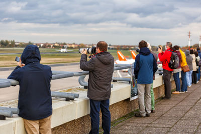 Rear view of people photographing