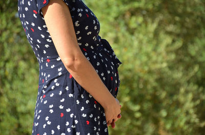 Midsection of woman standing outdoors