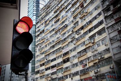 Low angle view of road sign against building