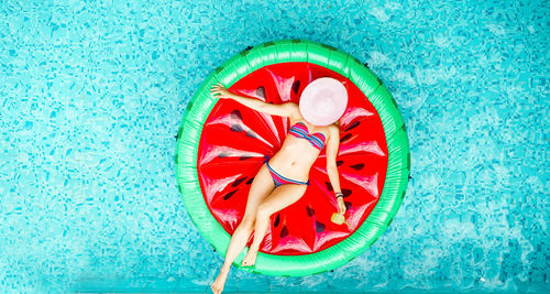 Directly above shot of woman floating in swimming pool