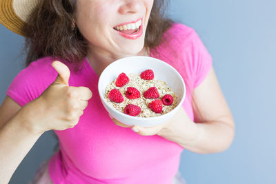 Midsection of woman holding ice cream