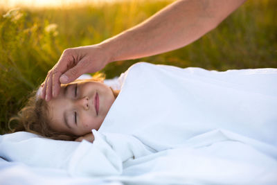 Midsection of woman lying on bed