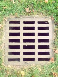 High angle view of manhole on field