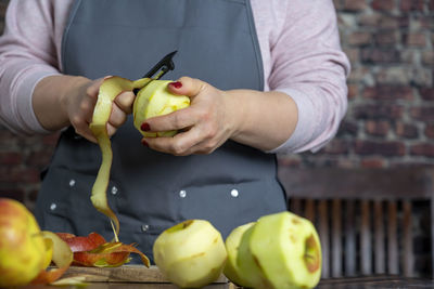 Women preparing delicious apple tart or pie large on wood table background.