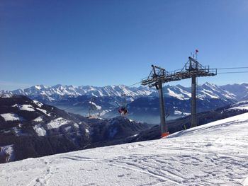 Scenic view of snowcapped mountains against clear blue sky