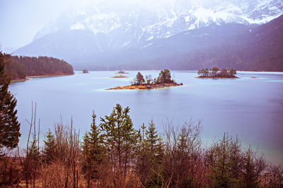 Scenic view of lake and mountains against sky