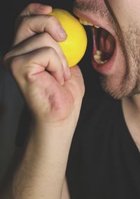 Close-up of man holding lemon 