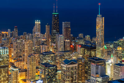 Aerial view of illuminated buildings in city at night