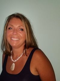 Portrait of a smiling young woman against white background