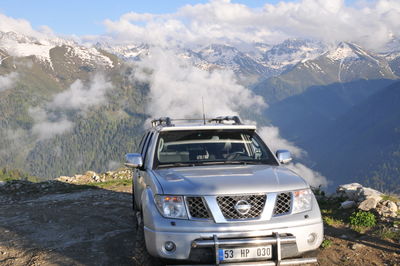 View of car on mountain range against sky