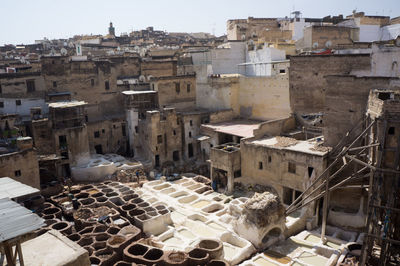 High angle view of tannery amidst houses in city on sunny day