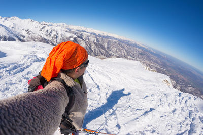 Tourists on snow covered landscape