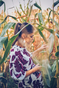 Side view of young woman standing outdoors