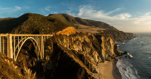 Arch bridge over sea against sky