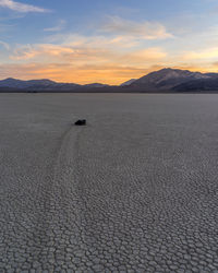 Scenic view of desert against sky during sunset