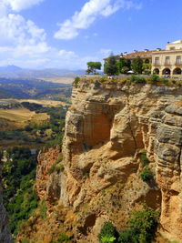 View of castle on mountain against cloudy sky