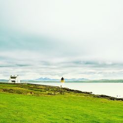 Scenic view of landscape against cloudy sky