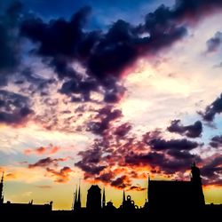 Silhouette of building against dramatic sky