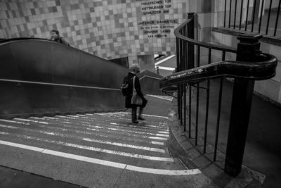 Woman standing on railing