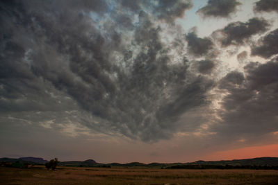 Scenic view of dramatic sky over land