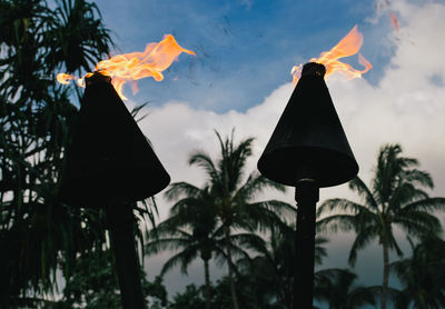 Low angle view of lanterns hanging against sky