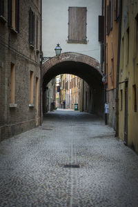 Empty alley amidst buildings in city