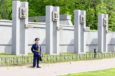 Full length of man standing by fence