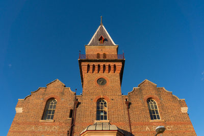 Low angle view of historic building against clear blue sky