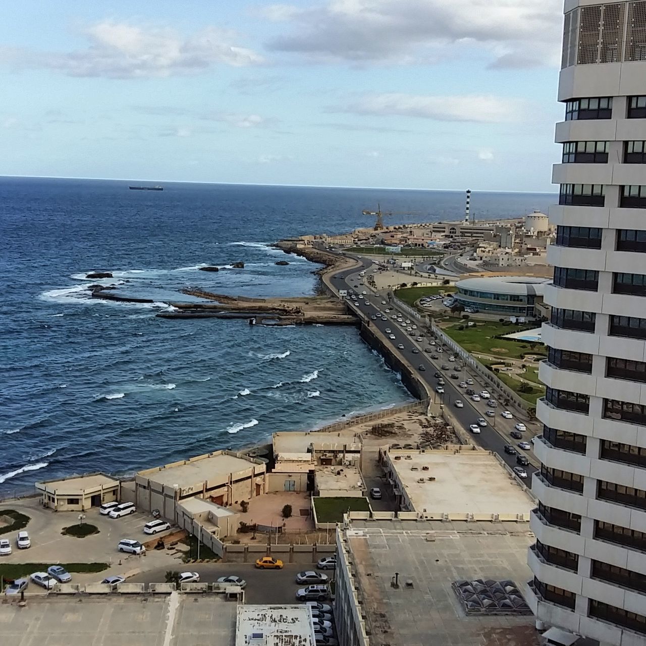 sea, water, sky, horizon, horizon over water, architecture, built structure, cloud - sky, high angle view, building exterior, beach, nature, scenics - nature, beauty in nature, day, city, land, no people, transportation, outdoors