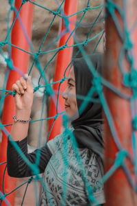 Midsection of woman holding rope