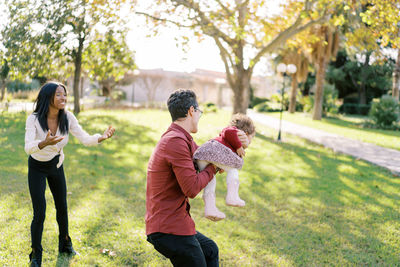 Side view of mother and daughter in park