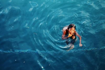 High angle view of girl swimming in pool