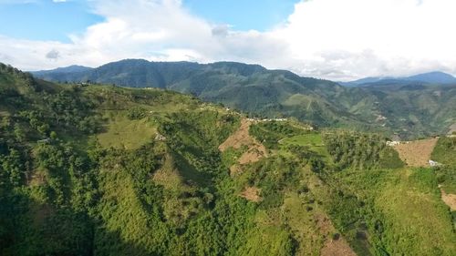 Scenic view of mountains against cloudy sky