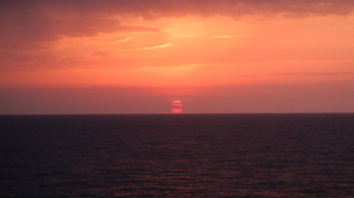 Scenic view of sea against romantic sky at sunset