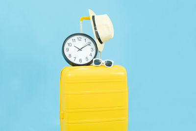 Close-up of clock tower against blue background