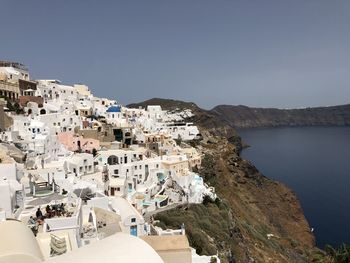 Townscape by sea against clear sky