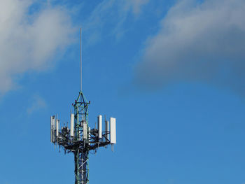 Low angle view of communications tower against sky