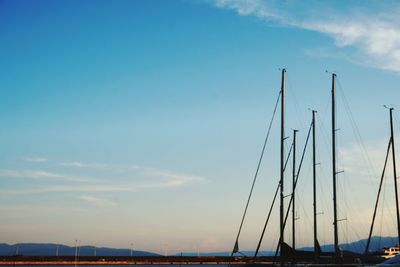 Sailboats in marina at sunset