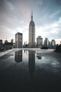 View of skyscrapers against cloudy sky