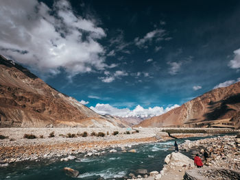 Scenic view of lake and mountains against sky