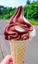 Close-up of hand holding ice cream cone