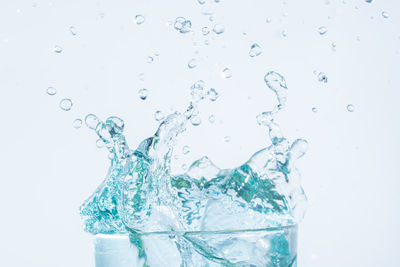 Close-up of splashing water against white background