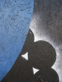 Shadow of person on road