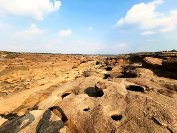 Scenic view of rocks on land against sky